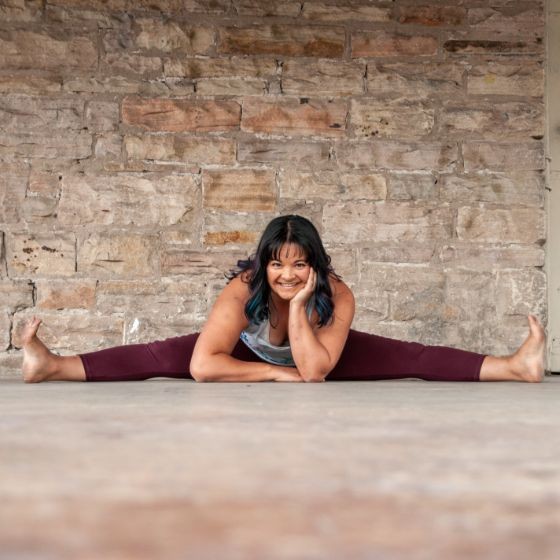 Yoga practitioner reaching into a side stretch at sunset
